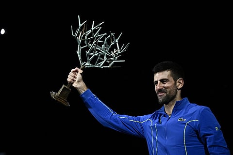 Serbia's Novak Djokovic celebrates with the trophy after winning the men's singles final match of the Paris ATP Masters 1000 tennis tournament against Bulgaria's Grigor Dimitrov. (Photo | AFP)