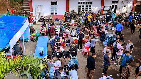 Polling officials at a distribution centre of EVMs and other election materials before the Mizoram Assembly election, in Lawngtlai district, on Nov. 5, 2023. (PTI)