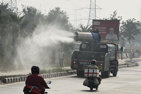 An anti-smog gun sprinkling water to make dust particles settle amid a rise in pollution levels on November 6, 2023, in New Delhi. (Parveen Negi)