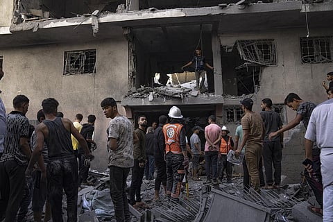 Palestinians look for survivors following an Israeli airstrike in Khan Younis refugee camp, southern Gaza Strip. (Photo | AP)