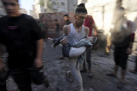 Palestinians evacuate survivors after Israeli airstrikes on buildings in Deir al Balah, Gaza Strip, Tuesday, Nov. 7, 2023. (Photo | AP)
