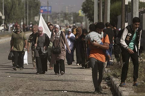 A woman carries a white flag to prevent being shot, as Palestinians flee Gaza City to the southern Gaza Strip on Salah al-Din street in Bureij, Tuesday, Nov. 7, 2023. (AP)