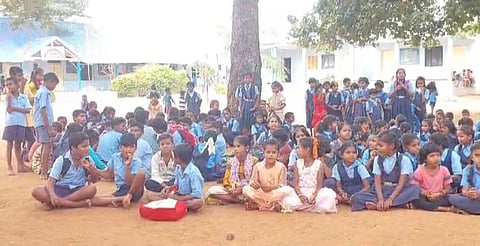 Students stage a protest in front of the school at Lakkalakatti village on Tuesday. (Photo | Express)