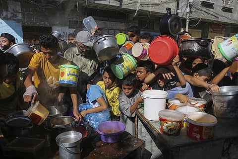 FILE - Palestinians crowded together as they wait for food distribution in Rafah, southern Gaza Strip, Wednesday, Nov. 8, 2023. (Photo | AP)