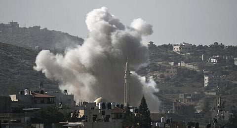 A photo taken from the city of Jenin, in the West Bank on November 9, 2023, shows smoke rising from the Jenin refugee camp during clashes between the Israeli military and Palestinians.(Photo |  AFP)