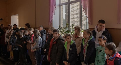 Children gather in a school during their evacuation to western Ukraine, from the southern city of Kherson. (Photo | AFP)