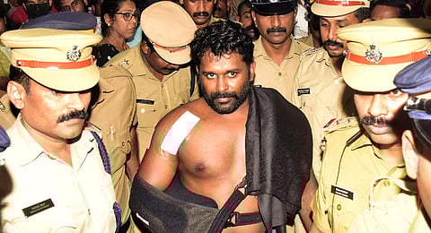 Maradu Aneesh with police personnel at Medical Trust Hospital in Kochi on  Wednesday. (Photo | A Sanesh, EPS)
