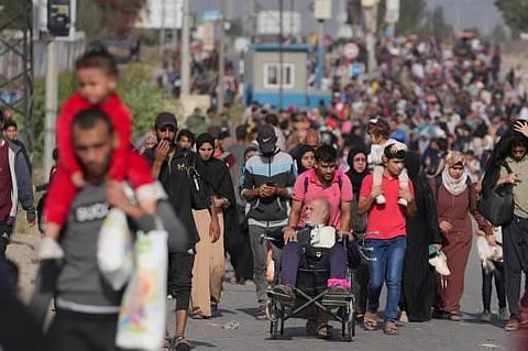Palestinians fleeing Gaza City and other parts of northern Gaza towards the southern areas, walk on a road on November 8, 2023. (AFP)