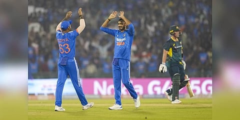 Indian bowler Axar Patel with captain Suryakumar Yadav celebrates the wicket of Australian batter Ben McDermott. (Photo | PTI)