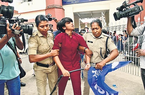 Police take a KSU worker into custody after members of the outfit took out a protest march to the Kanayannur Taluk Office in Kochi demanding resignation of Higher Education Minister R Bindu in the wak