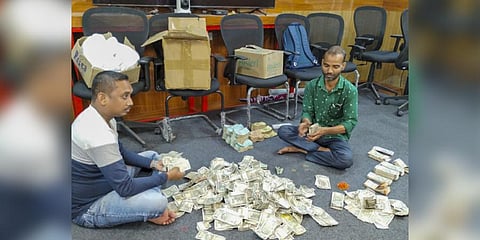 Counting of cash by officials on the 5th day of the Income Tax department raids against Odisha-based distillery and linked entities, in Ranchi. (Photo | PTI)