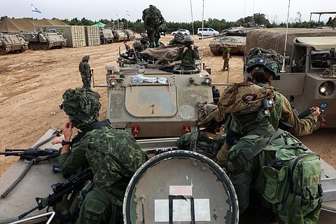 Israeli troops prepare weapons and military vehicles by the border fence before entering the Gaza Strip on December 10, 2023, amid ongoing battles with the Palestinian Hamas group. (Photo | AFP)