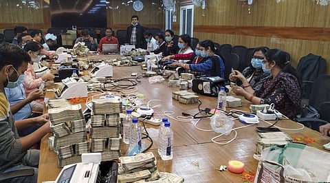 Counting of cash by officials on the 5th day of the Income Tax department raids against Odisha-based distillery and linked entities, in Ranchi on Sunday, December 10, 2023. (Photo | PTI)