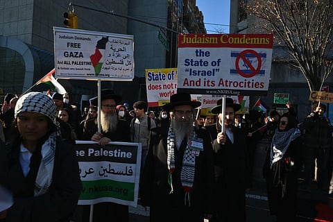 Pro Palestine protesters demonstrate outside UN headquarters prior to a vote at the General Assembly in New York City on December 12, 2023. (Photo | AFP)