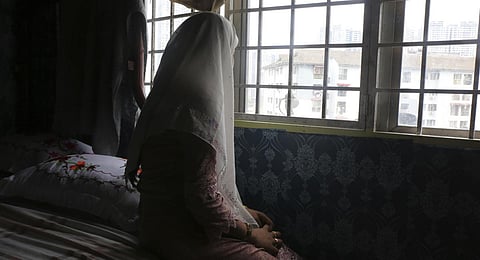Rohingya child bride, B, age 14, sits on a bed in an apartment in Kuala Lumpur, Malaysia. (Photo | AP)