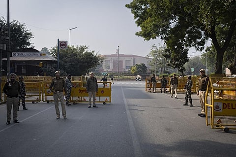 Security officers stand guard at a checkpoint outside the Indian parliament in New Delhi, a day after the security breach in Lok Sabha, Dec. 14, 2023. (Photo | AP)