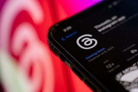 FILES - This photo illustration created in Washington, DC, on July 5, 2023, shows Threads, an Instagram app, on the App Store, in front of the logos of Instagram and Threads. (AFP Photo)