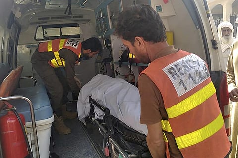 Rescue workers load a body of a police officer, who was killed in a militant attack, into an ambulance at a hospital in Tank, Pakistan, Friday, Dec. 15, 2023. (AP Photo)
