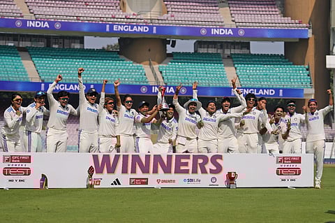Indian players pose with the trophy after winning the one-off Test cricket match against England, at DY Patil Stadium, in Navi Mumbai on Saturday, December 16, 2023. (Photo | PTI)
