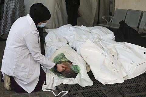 A Palestinian nurse mourns a relative killed in the Israeli bombardment of the Gaza Strip outside a hospital's morgue in Rafah (Photo | AP)
