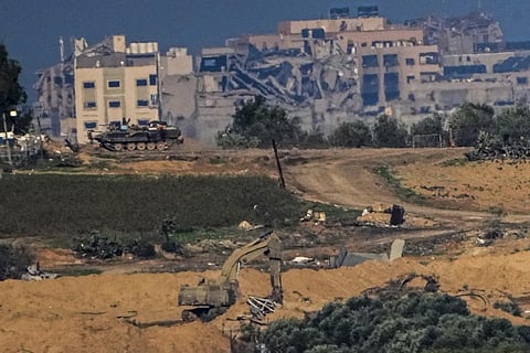 Israeli military vehicles operate in side Gaza Strip, as seen from southern Israel, Sunday, Dec. 17, 2023. (AP Photo)