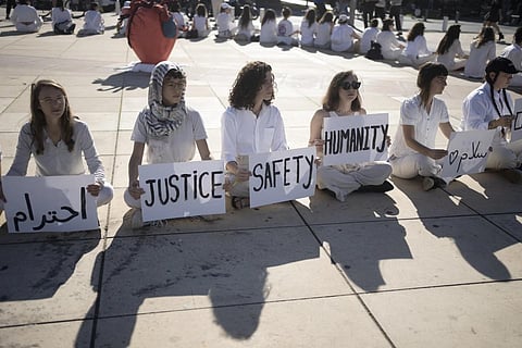 Women hold placards in Arabic, Hebrew and English during a demonstration by Israeli and Palestinian women calling for peace, in Tel Aviv, Dec 15, 2023. (Photo | AP)