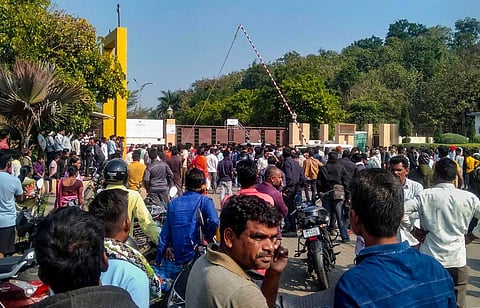 Workers and locals outside a manufacturing unit of Solar Industries after a blast at the factory, at Bazargaon near Nagpur, Sunday, Dec. 17, 2023. (PTI Photo)