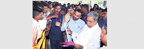 Karnataka CM Siddaramaiah accepting grievances from the public at Hubballi airport on Saturday. (Photo | D HEMANTH, EPS)
