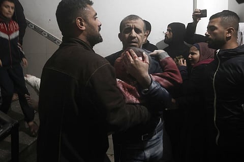 Palestinians evacuate a wounded boy following Israeli strikes on the maternity ward at Nasser Hospital in the town of Khan Younis, southern Gaza Strip, Sunday, Dec. 17, 2023. (AP Photo)