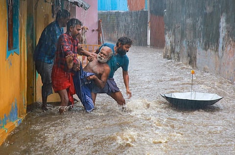 People rescue an elderly man from a flooded area during heavy rain, in Kanyakumari district, Sunday, Dec. 17, 2023. (PTI Photo)