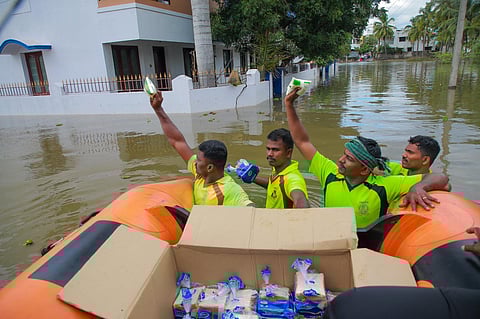 Rescue workers provide water and other relief material to flood-hit people in Kanyakumari, Monday. (Photo | PTI)