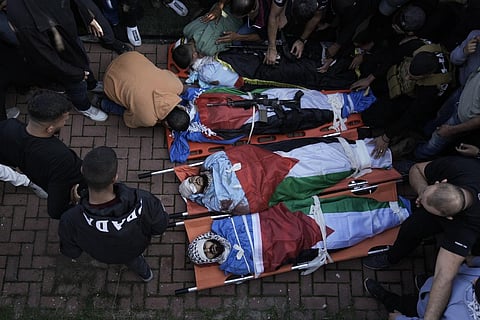 Friends and relatives attend the funeral of Palestinians killed during an Israeli military raid on the Fara'a refugee camp in the West Bank on Monday. (Photo | AP)