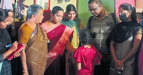 Child Welfare department officials interacting with the nine-year-girl at her  house in Kurnool city on Monday.(Photo | Express)