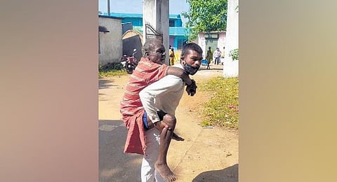 Elderly paralytic piggybacks 8-km to collect pension.