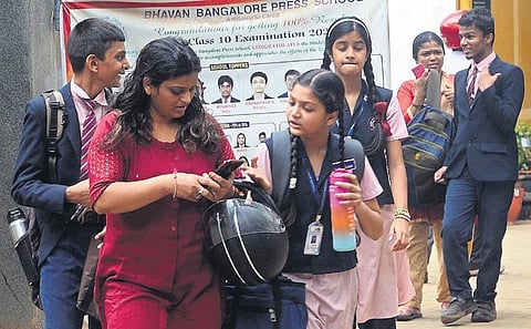 Parents collect their wards from school. The bomb squad checks a school