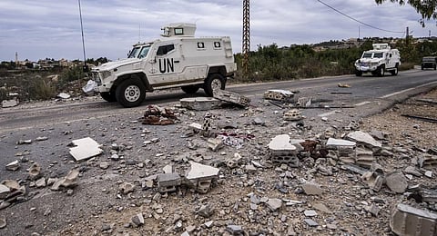 U.N. peacekeepers patrol next to a damage house in the Lebanese side of the Lebanese-Israeli border. (Photo | AP)