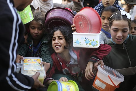 Palestinians line up for a free meal in Rafah, Gaza Strip, Wednesday. (Photo | AP)