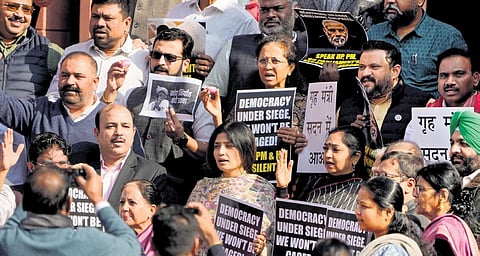 Suspended Opposition MPs protest outside Parliament in New Delhi on Tuesday | PTI