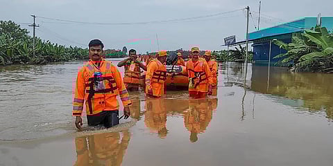NDRF personnel rescue passengers near a railway station amid floods after heavy rainfall, in Tamil Nadu. (Photo | PTI)