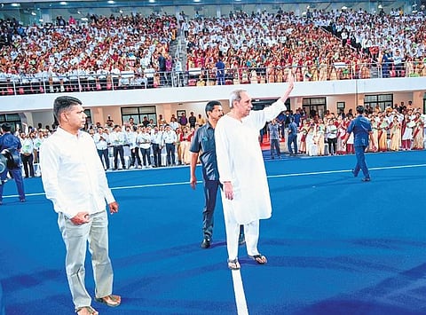 Chief Minister Naveen Patnaik waving to the crowd at the Nijukti mela at Kalinga Stadium. Also seen is 5T chairman VK Pandian | Express