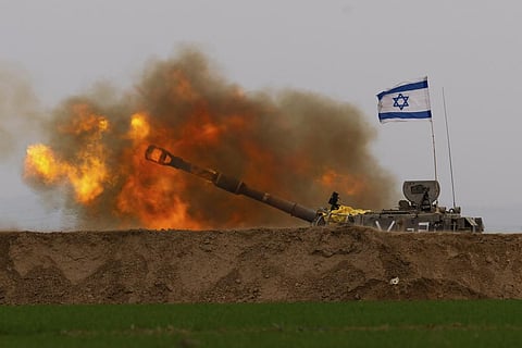 An Israeli mobile artillery unit fires a shell from southern Israel towards the Gaza Strip, in a position near the Israel-Gaza border. (Photo | AP)