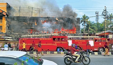 Fire and Rescue Services personnel dousing the fire that broke out in a  three-storey building at Karukutty near Angamaly on Friday | Express
