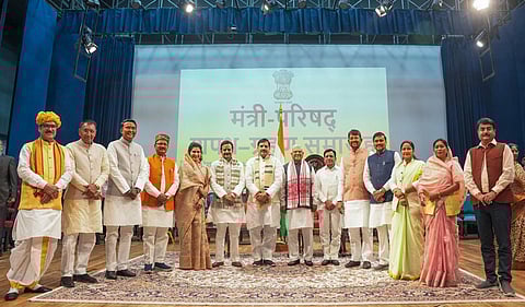 Madhya Pradesh Governor Mangubhai Patel and Chief Minister Mohan Yadav pose for a group photo with the newly inducted ministers of the State Cabinet on Monday, December 25, 2023. (Photo | PTI)