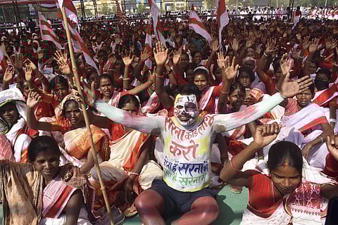 Tribals wearing traditional attire take part in a Maharally demanding separate 'Sarna Dharm Code' for tribals, at Morhabadi grounds in Ranchi, on Mar 12, 2023. (Photo | PTI)