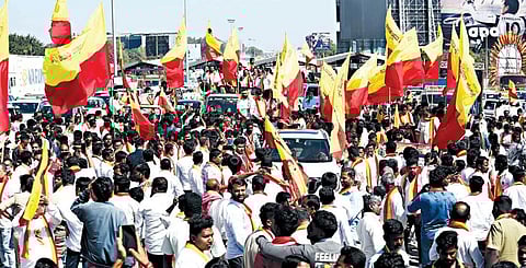 Kannada Rakshana Vedike members take out a rally on KIA Road in Bengaluru demanding commercial establishments use Kannada on name boards, on Wednesday