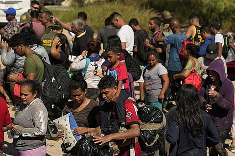 Migrants wait to be processed by the U.S. Customs and Border Patrol after they crossed the Rio Grande and entered the U.S. from Mexico. (Photo | AP)