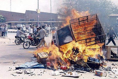 A  vehicle burning during the 2002 Gujarat riots in 2002. (File Photo | PTI)