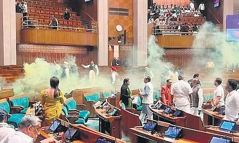 Accused opening canisters of yellow smoke in Lok Sabha on December 13 | FILE