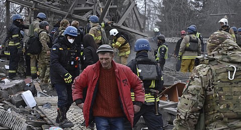 People clear the debris at the site of Russia's air attack in Zaporizhzhia, Ukraine. (Photo | AP)