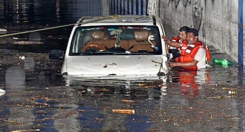 Rescuers pull out the SUV that was stranded in the waterlogged underpass near KR Circle after a heavy rainfall in Bengaluru - Express Photo.